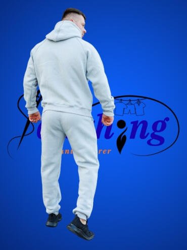 back side view of the model wearing a tracksuit by colthing manufacturer usa 1
