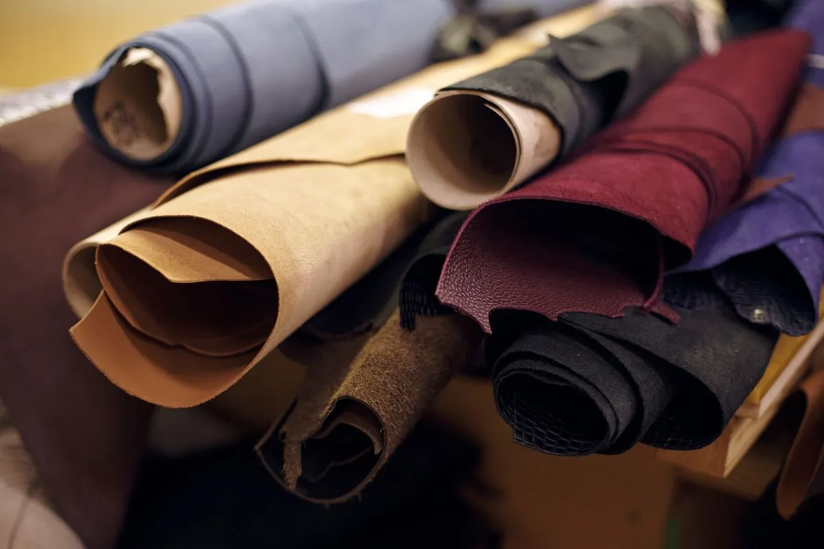 Duck canvas, waxed cotton, and corduroy fabric swatches used in barn jacket manufacturing
