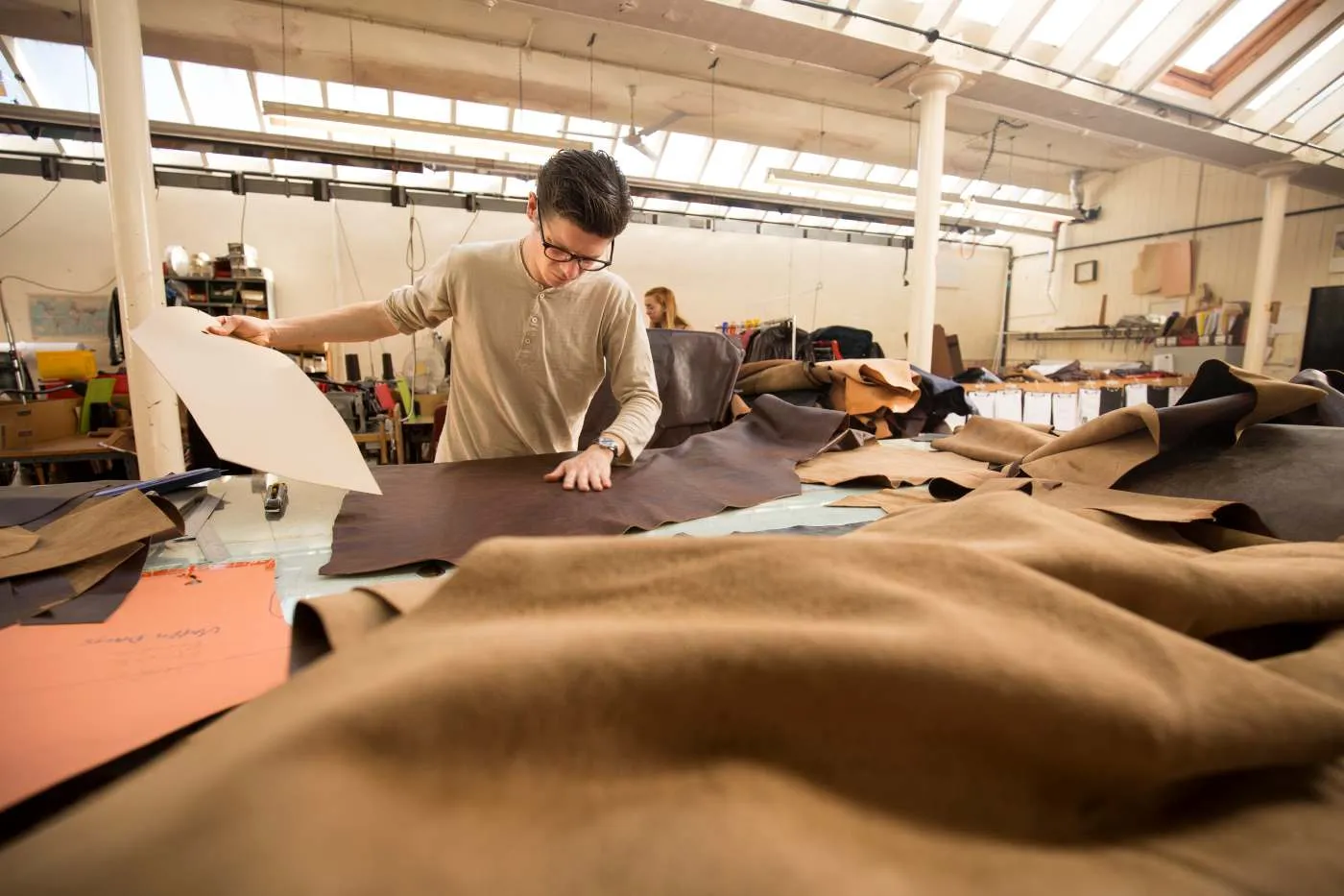 Barn jacket manufacturer USA factory floor cutting and sewing waxed canvas jackets